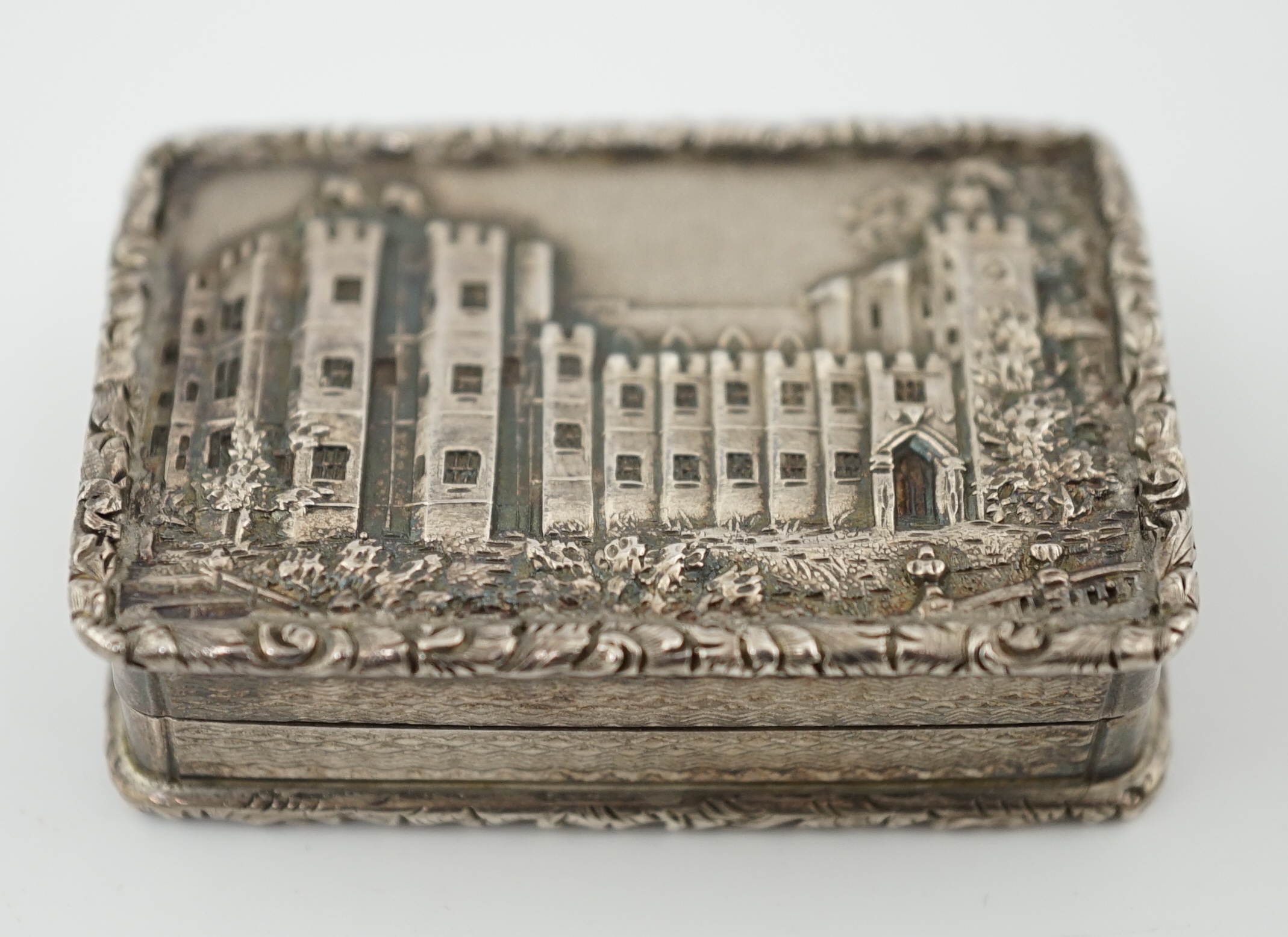 A George IV engine turned silver castle top rectangular vinaigrette, by Francis Clark, depicting ‘Kenilworth Castle’ in relief